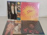 three cds of various albums, including a man in a suit and a woman in a pink shirt