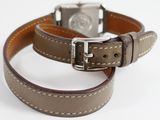 two brown leather straps with silver buckles on a white surface