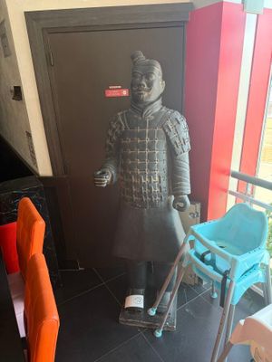 a statue of a man with a walker in a room