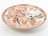 a plate with a painting on it on a white surface