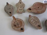 several pieces of pottery are displayed on a table with a price tag