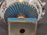 a blue and white vase sitting on a table