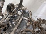 a silver plate with a handle and a handle on it