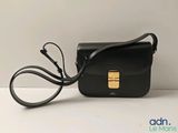 the small black bag is sitting on a white surface