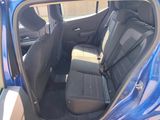a blue car that is sitting in the back of the car