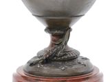 an image of a silver vase with a bird on it