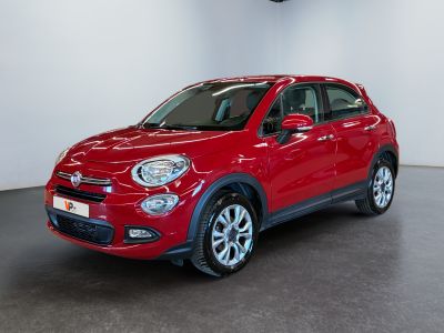 the red fiat suv is parked in a large room