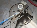 a machine that is sitting on the floor next to a hose