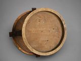 a close up of a wooden bowl on a gray surface