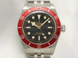 a red and black watch on a silver bracelet