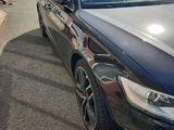 a picture of a black car parked in a parking lot