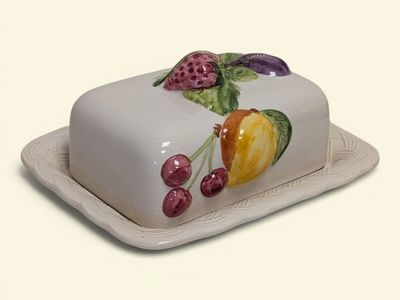 a white cake with fruit on it on a plate