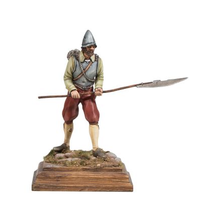 statue of a man with a spear and shield on a wooden base