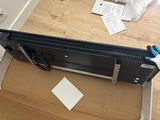 a television sitting on top of a cardboard box on the floor