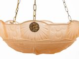 a glass bowl hanging from a chain on a white background