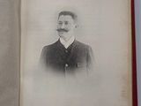 an old book with a picture of a man in a suit and tie