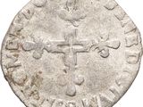 an old silver coin with a cross on it