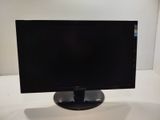 a computer monitor sitting on top of a white table