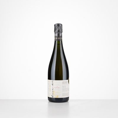 a bottle of wine sitting on top of a white table