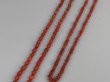 a pair of coral beaded necklaces with gold clasp