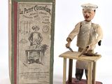 a figurine of a man with a knife in front of a box
