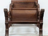 an old wooden chair sitting on top of a wooden floor
