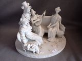 a figurine of a group of people sitting on a bench