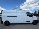 a white van parked in a parking lot next to a building