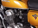 a yellow motorcycle parked in a garage with a black seat