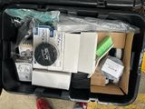 a suitcase full of electronic equipment on the ground