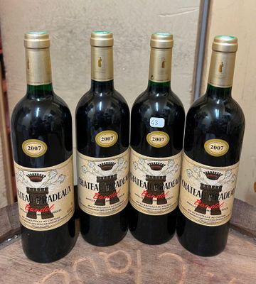 four bottles of wine are lined up on a wooden table