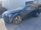 a blue audi suv parked in front of a building