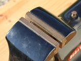 a close up of a fork on a wooden table