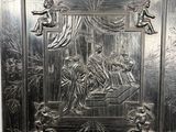 a metal plaque with a picture of a man and a woman on it