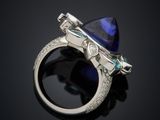 a close up of a ring with a blue stone in it
