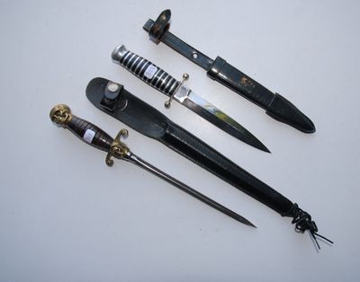 several different types of knives are lined up on a white surface