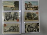 several old postcards are hanging on a wall in a room