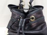 a black purse with a gold buckle on it