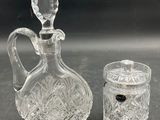 pair of cut glass decanters and a glass jar