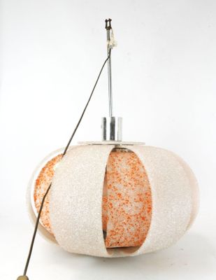 a white and orange lamp that is on top of a table