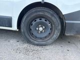 a white van that has a flat tire on it