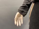a mannequin hand that is wearing a black dress