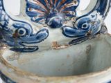 a blue and white vase with a flower decoration on it