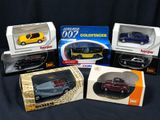 four different models of cars in boxes on a black background
