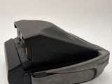 a close up of a black object on a white surface