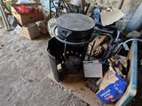 a pile of junk on the ground next to a wall