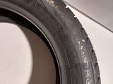 a close up of a tire on a white surface next to a wall