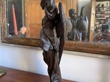 a statue of an angel on a table in front of a mirror