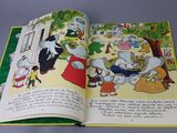 an open book with a picture of a family of animals