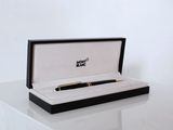 a pen sitting in a black box on a table